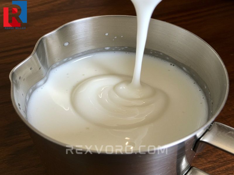 a-close-up-of-glossy-shiny-microfoam-in-a-steel-pitcher-flowing-like-wet-paint-showing-the-ideal-cappuccino-texture