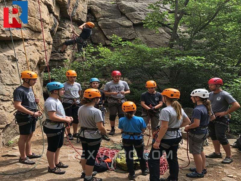 campers-receiving-safety-instruction-at-a-rock-climbing-camp-orientation
