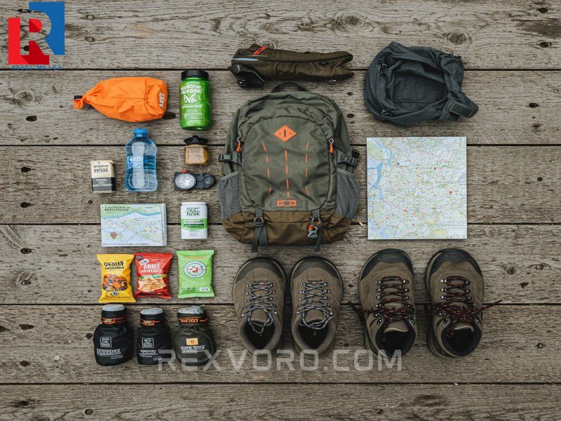 essential-day-hike-gear-flat-lay-boots-backpack-water-bottle-map-compass-and-snacks