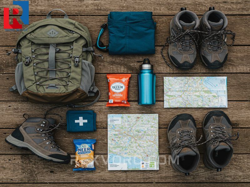 flat-lay-of-essential-hiking-gear-boots-daypack-map-water-bottle-and-first-aid-kit