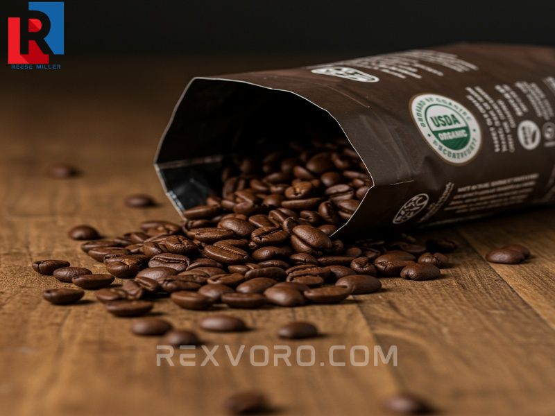 medium-roasted-decaf-coffee-beans-spill-from-a-bag-with-a-visible-usda-organic-certification-seal