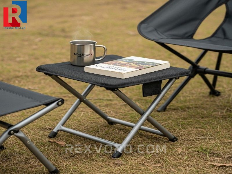 multi-functional-folding-footstool-used-as-a-stable-side-table-next-to-a-camp-chair-with-footrest
