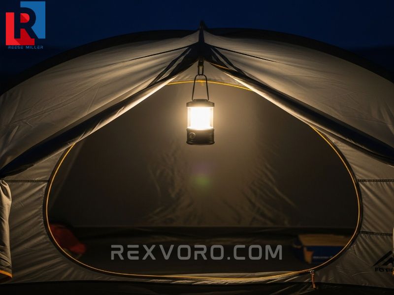 small-led-lantern-hangs-inside-a-tent-at-night-casting-a-warm-glow